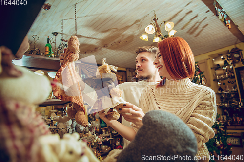 Image of Smiling family, couple looking for home decoration and holiday\'s gifts in household store