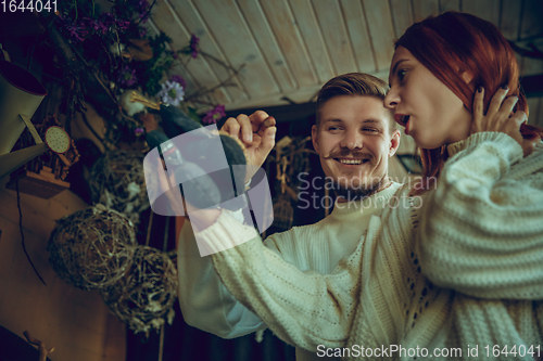 Image of Smiling family, couple looking for home decoration and holiday\'s gifts in household store