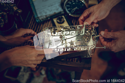 Image of Close up hands of couple looking for home decoration and holiday\'s gifts in household store