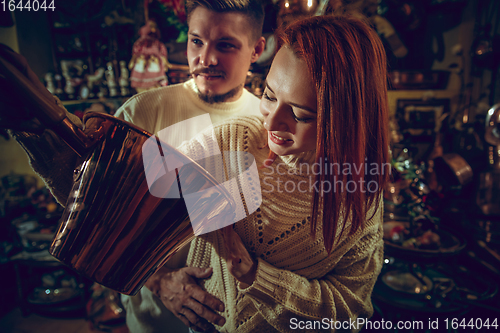 Image of Smiling family, couple looking for home decoration and holiday\'s gifts in household store