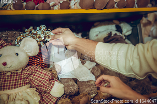 Image of Close up hands of woman looking for home decoration and holiday\'s gifts in household store