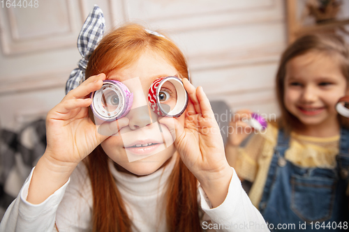 Image of Two little children, girls together in creativity of the house. Happy kids make handmade toys for games or New Year celebration