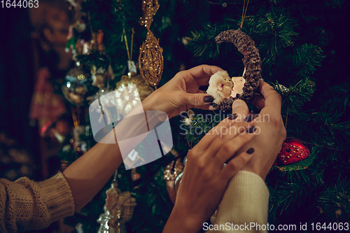 Image of Close up hands of couple looking for home decoration and holiday\'s gifts in household store