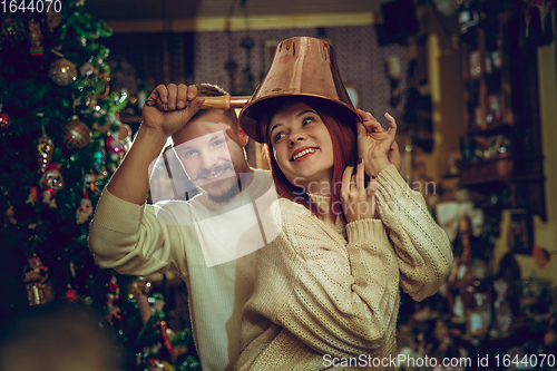 Image of Smiling family, couple looking for home decoration and holiday\'s gifts in household store