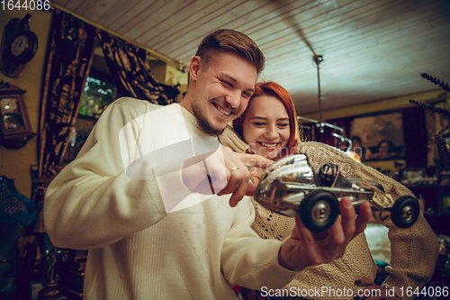 Image of Smiling family, couple looking for home decoration and holiday\'s gifts in household store