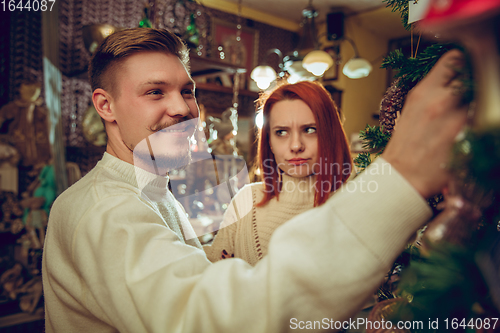 Image of Smiling family, couple looking for home decoration and holiday\'s gifts in household store