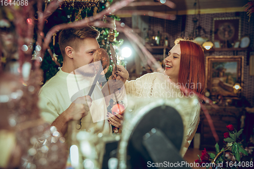 Image of Smiling family, couple looking for home decoration and holiday\'s gifts in household store