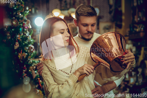 Image of Smiling family, couple looking for home decoration and holiday\'s gifts in household store