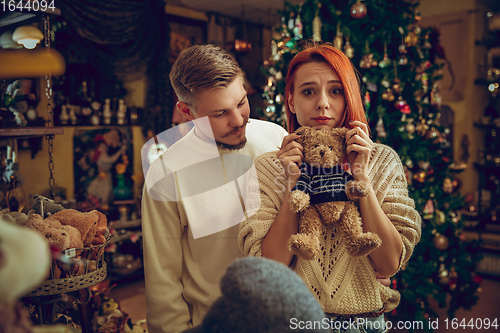 Image of Smiling family, couple looking for home decoration and holiday\'s gifts in household store