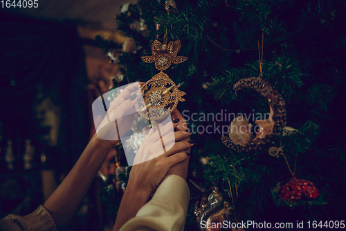 Image of Close up hands of couple looking for home decoration and holiday\'s gifts in household store