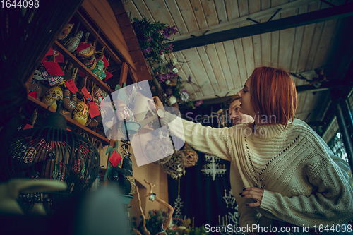 Image of Smiling family, couple looking for home decoration and holiday\'s gifts in household store