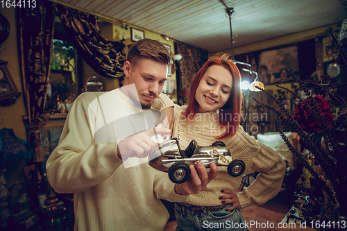 Image of Smiling family, couple looking for home decoration and holiday\'s gifts in household store