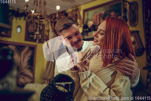 Image of Smiling family, couple looking for home decoration and holiday\'s gifts in household store