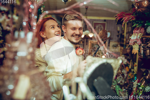 Image of Smiling family, couple looking for home decoration and holiday\'s gifts in household store