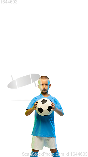 Image of Young boy with soccer ball isolated on white studio background, vertical flyer with copyspace