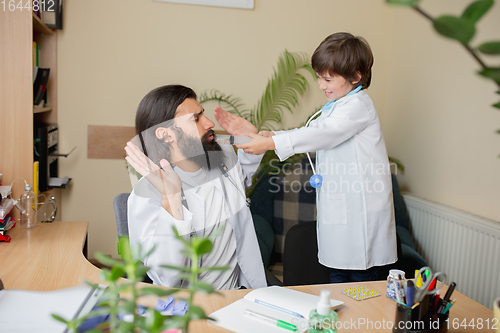 Image of Paediatrician doctor examining a child in comfortabe medical office