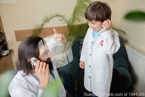 Image of Paediatrician doctor examining a child in comfortabe medical office