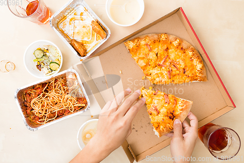 Image of Top view of eating pizza at home