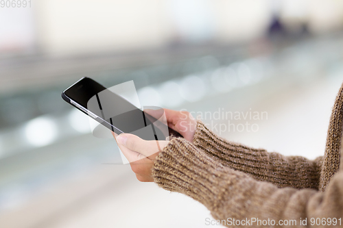 Image of Woman touch on screen of mobile phone