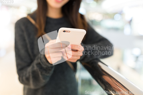 Image of Woman sending sms on cellphone