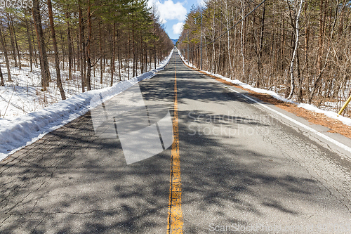 Image of Traffic road in forest at winter time