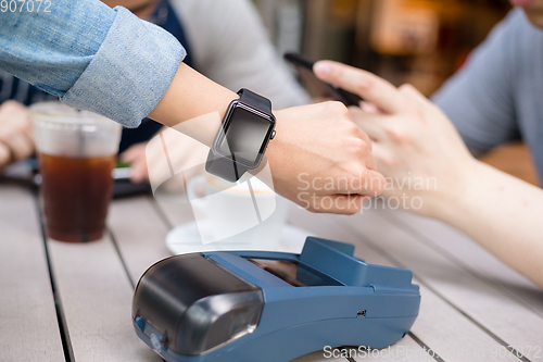 Image of Woman using cellphone to pay