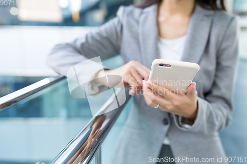 Image of Businesswoman sending sms on mobile phone