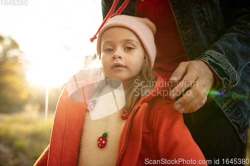 Image of Happy father and little cute daughter walking down the forest path in autumn sunny day