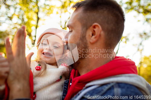 Image of Happy father and little cute daughter walking down the forest path in autumn sunny day