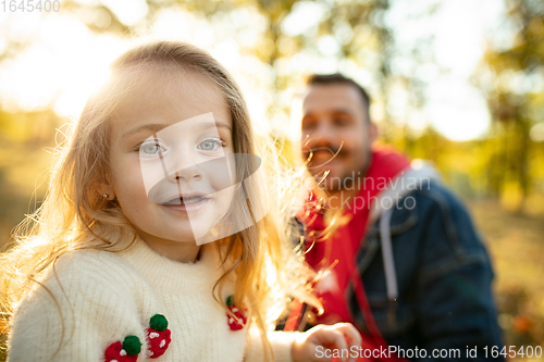 Image of Happy father and little cute daughter walking down the forest path in autumn sunny day