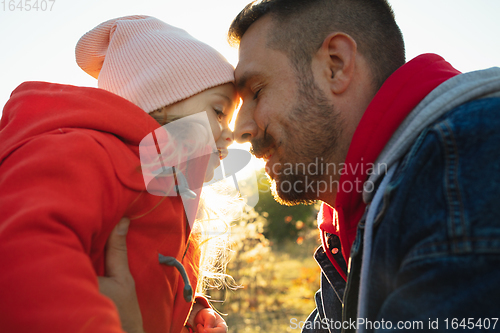 Image of Happy father and little cute daughter walking down the forest path in autumn sunny day