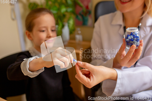 Image of Paediatrician doctor examining a child in comfortabe medical office