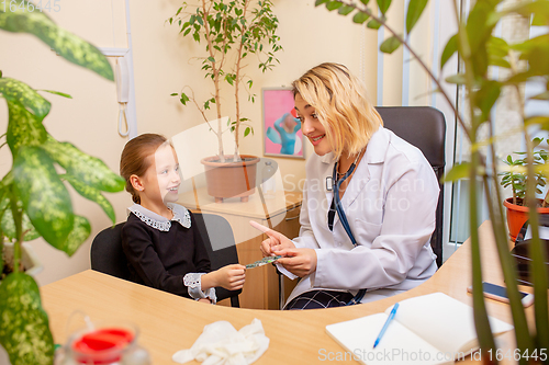 Image of Paediatrician doctor examining a child in comfortabe medical office