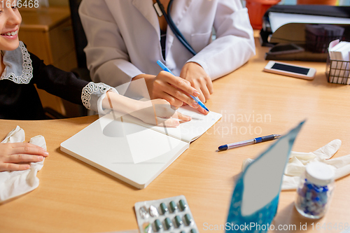 Image of Paediatrician doctor examining a child in comfortabe medical office