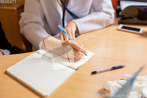 Image of Paediatrician doctor examining a child in comfortabe medical office