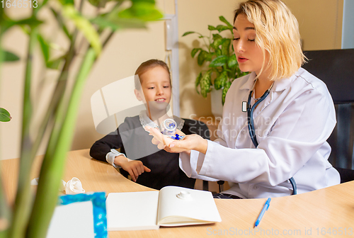 Image of Paediatrician doctor examining a child in comfortabe medical office