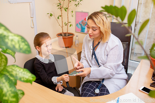 Image of Paediatrician doctor examining a child in comfortabe medical office