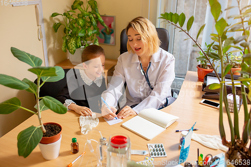 Image of Paediatrician doctor examining a child in comfortabe medical office