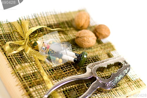 Image of nutcracker, walnuts and decorations