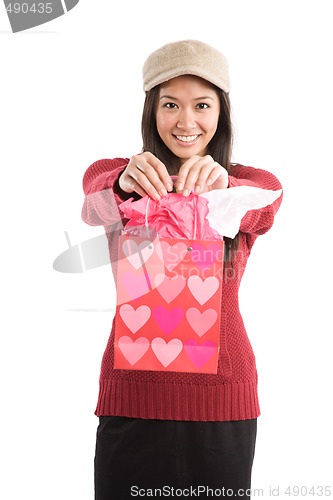 Image of Asian girl carrying valentine gift