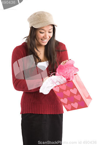 Image of Asian girl opening valentine gift