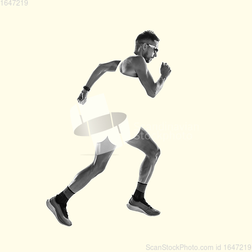 Image of Young caucasian sportsman isolated on studio background, modern artwork. Healthy lifestyle, movement, action, motion, advertising and sports concept. Abstract design.