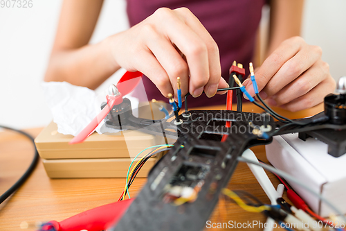 Image of Building of flying drone with connecting cable