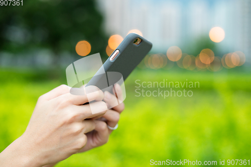Image of Woman use of mobile phone at outdoor