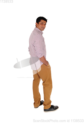 Image of Man standing in profile in brown pants