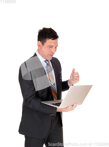 Image of Business man reading on his laptop and is happy
