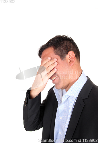 Image of Business man covering is face for stress