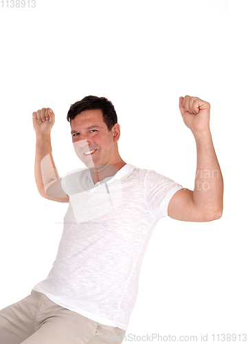 Image of Happy man lifting his fists for excitement