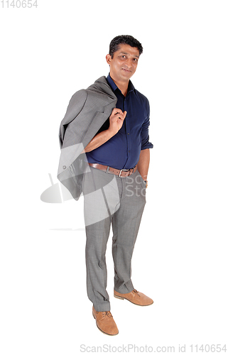 Image of Business man standing with his jacket over shoulder