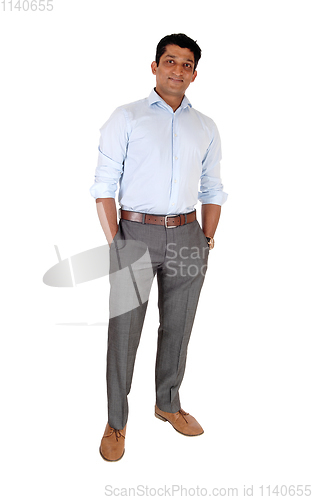 Image of Relaxed East Indian man standing hands in pocket